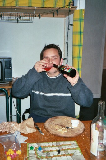 Stefan demonstrating his dual cultural nature by drinking both wine and beer at the same time